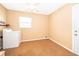 Bright laundry room offers a washer, storage shelving, and natural light from the window at 275 Tollgate Trl, Longwood, FL 32750