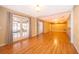 Bright living room with hardwood floors, open doorway, leading to an enclosed patio with lots of natural light at 275 Tollgate Trl, Longwood, FL 32750