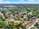 A beautiful aerial view of a neighborhood with mature trees and manicured lawns with a lake in the distance at 2811 Citron Dr, Longwood, FL 32779