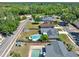 A bird's-eye view displays a well-manicured backyard with a refreshing pool, green lawn, and surrounding greenery at 2811 Citron Dr, Longwood, FL 32779