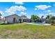 Spacious backyard featuring a swimming pool, screened in porch, lush green grass, and partial fence at 2811 Citron Dr, Longwood, FL 32779