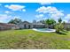 Expansive backyard featuring a swimming pool, screened in porch, lush green grass, and partial fence at 2811 Citron Dr, Longwood, FL 32779