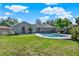 Extensive backyard featuring a swimming pool, screened in porch, lush green grass, and partial fence at 2811 Citron Dr, Longwood, FL 32779