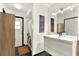 Bright bathroom featuring modern vanity with a large mirror and stylish light fixtures at 2811 Citron Dr, Longwood, FL 32779