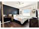 Modern bedroom boasts hardwood floors, a black accent wall, and stylish furnishings for a relaxing space at 2811 Citron Dr, Longwood, FL 32779