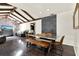 Open dining room with brick accent wall featuring vaulted ceilings and wood-like vinyl flooring at 2811 Citron Dr, Longwood, FL 32779