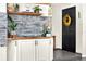 Stylish entryway with floating shelf, decorative accents, and modern gray stacked stone feature wall at 2811 Citron Dr, Longwood, FL 32779