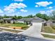 Desirable single-Gathering home showcasing manicured landscaping, a long driveway, and an attached two-car garage at 2811 Citron Dr, Longwood, FL 32779