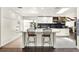 Contemporary kitchen features white countertops and cabinetry, stainless appliances, and stylish barstool seating at 2811 Citron Dr, Longwood, FL 32779