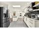 Modern kitchen featuring stainless steel appliances, quartz countertops, and stylish black backsplash at 2811 Citron Dr, Longwood, FL 32779