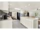 Modern kitchen island with white cabinets, quartz countertops, and stainless steel appliances at 2811 Citron Dr, Longwood, FL 32779
