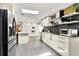 Modern kitchen featuring stainless steel appliances, quartz countertops, and stylish black backsplash at 2811 Citron Dr, Longwood, FL 32779