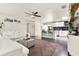 Open concept living room and kitchen featuring bright white kitchen, white couches, and a decorative rug at 2811 Citron Dr, Longwood, FL 32779
