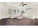 Bright living room featuring two sofas, a ceiling fan, and three sunny windows with a decorative area rug at 2811 Citron Dr, Longwood, FL 32779