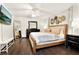 Bright main bedroom featuring hardwood floors, ceiling fan, and decorative wall art at 2811 Citron Dr, Longwood, FL 32779