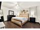 Spacious main bedroom boasts hardwood floors, a ceiling fan, and neutral tones, creating a serene retreat at 2811 Citron Dr, Longwood, FL 32779