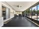 Large enclosed sunroom/patio with sliding windows, a sleek dark-colored floor, and backyard access at 2811 Citron Dr, Longwood, FL 32779