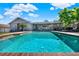 Inviting backyard with large pool, covered patio, and ample seating, ideal for relaxing and entertaining at 2811 Citron Dr, Longwood, FL 32779