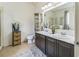 Bathroom with double vanity, decorative accessories, toilet, and a separate shower in the background at 2815 Shelburne Way, St Cloud, FL 34772