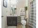 Bathroom with a vanity, toilet, decorative towels and a shower with gray and white striped curtain at 2815 Shelburne Way, St Cloud, FL 34772