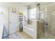 Bathroom featuring a bathtub, separate shower, storage shelves, and a door to the outside at 2815 Shelburne Way, St Cloud, FL 34772
