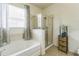 Bathroom featuring a bathtub, separate shower, and a decorative shelf unit with woven storage baskets at 2815 Shelburne Way, St Cloud, FL 34772