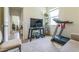 A bedroom with natural light, featuring a desk, treadmill, and neutral tones, offering a versatile space at 2815 Shelburne Way, St Cloud, FL 34772