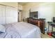 Bedroom with large closet, dresser and tv with view to attached bath at 2815 Shelburne Way, St Cloud, FL 34772