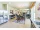 Open kitchen and dining area with stainless steel appliances and access to outdoor patio at 2815 Shelburne Way, St Cloud, FL 34772