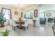 Bright dining room features modern lighting, neutral walls and tile, and white dining chairs at 2815 Shelburne Way, St Cloud, FL 34772