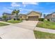 Street view of a well-maintained single-Gathering home with a lush lawn, 2 car garage, and sidewalks at 2815 Shelburne Way, St Cloud, FL 34772