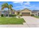 Charming single-Gathering home with a well-manicured lawn, lush landscaping, and a two-car garage at 2815 Shelburne Way, St Cloud, FL 34772