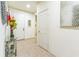 Hallway with tile flooring, white walls, and art, creating a clean and airy feel throughout the home at 2815 Shelburne Way, St Cloud, FL 34772