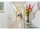 Long, tiled hallway featuring decorative elements and natural light, connecting various areas of the home at 2815 Shelburne Way, St Cloud, FL 34772