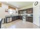 Well-equipped kitchen with stainless steel appliances, dark cabinetry, and granite countertops at 2815 Shelburne Way, St Cloud, FL 34772