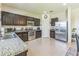 Functional kitchen with stainless steel appliances, dark wood cabinets, and ample counter space at 2815 Shelburne Way, St Cloud, FL 34772