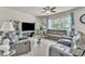 Bright living room showcasing comfortable leather sofas, mirrored accents, and natural light at 2815 Shelburne Way, St Cloud, FL 34772