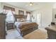 Spacious main bedroom with king bed, decorative window treatments, and ensuite bathroom at 2815 Shelburne Way, St Cloud, FL 34772