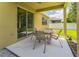 Covered patio with an outdoor dining set, offering a relaxing space for outdoor entertaining and dining at 2815 Shelburne Way, St Cloud, FL 34772