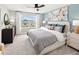 Bright bedroom with a large window, neutral carpet, a ceiling fan, and tastefully coordinated decor at 2823 Camellia Flower St, Apopka, FL 32703