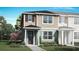 Charming two-story home with tan and blue siding, complemented by a well-maintained green lawn and landscaping at 2823 Camellia Flower St, Apopka, FL 32703