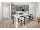 Modern kitchen with sleek gray cabinetry, a central island with seating, and high-end stainless steel appliances at 2823 Camellia Flower St, Apopka, FL 32703