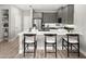 Modern kitchen boasts gray cabinets, stainless steel appliances, and a quartz countertop island with barstool seating at 2823 Camellia Flower St, Apopka, FL 32703