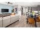 Open-concept living room featuring modern furnishings, a dining table, and seamless connection to the kitchen at 2823 Camellia Flower St, Apopka, FL 32703