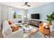 Bright living room showcasing a comfortable sectional sofa, stylish decor, and abundant natural light at 2823 Camellia Flower St, Apopka, FL 32703