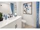 Chic bathroom with a modern vanity, elegant mirror, and stylish blue accents at 2831 Camellia Flower St, Apopka, FL 32703
