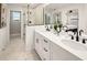 Modern bathroom boasts double sinks, a sleek glass-enclosed shower, and contemporary finishes at 2831 Camellia Flower St, Apopka, FL 32703