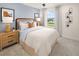 Cozy bedroom with stylish decor, a comfortable bed, and a large window overlooking the yard at 2831 Camellia Flower St, Apopka, FL 32703