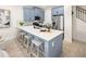 Modern kitchen with blue cabinets, an island with seating, and stainless steel appliances at 2831 Camellia Flower St, Apopka, FL 32703