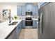 Modern kitchen with blue cabinets, a large island, and stainless steel appliances at 2831 Camellia Flower St, Apopka, FL 32703